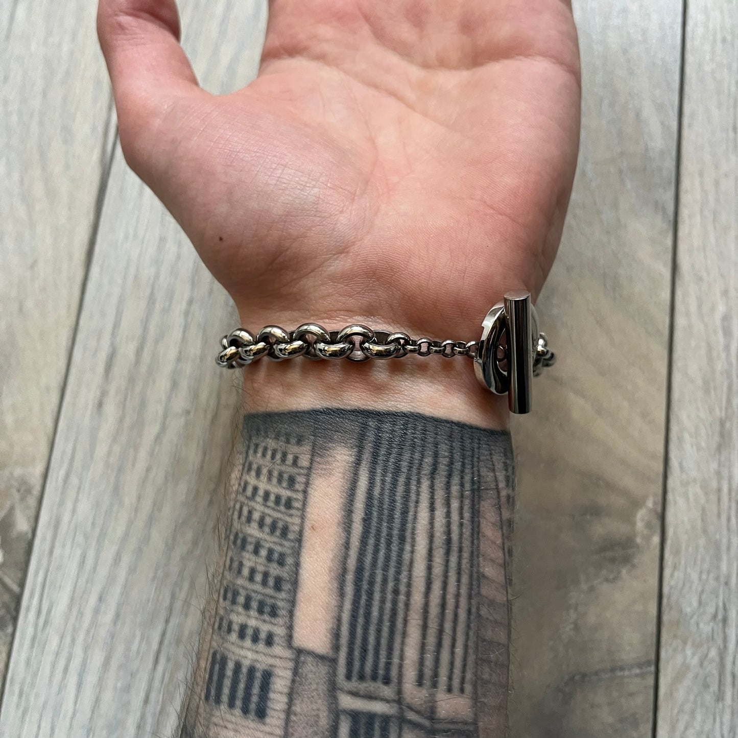 Dolce & Gabbana DJ0162 stainless steel bracelet from a three-bracelet watch set release. Constructed with round link chain segments and secured with a T-bar clasp. The clasp hardware includes engraved D&G branding on the T-bar and on the circular locking ring.