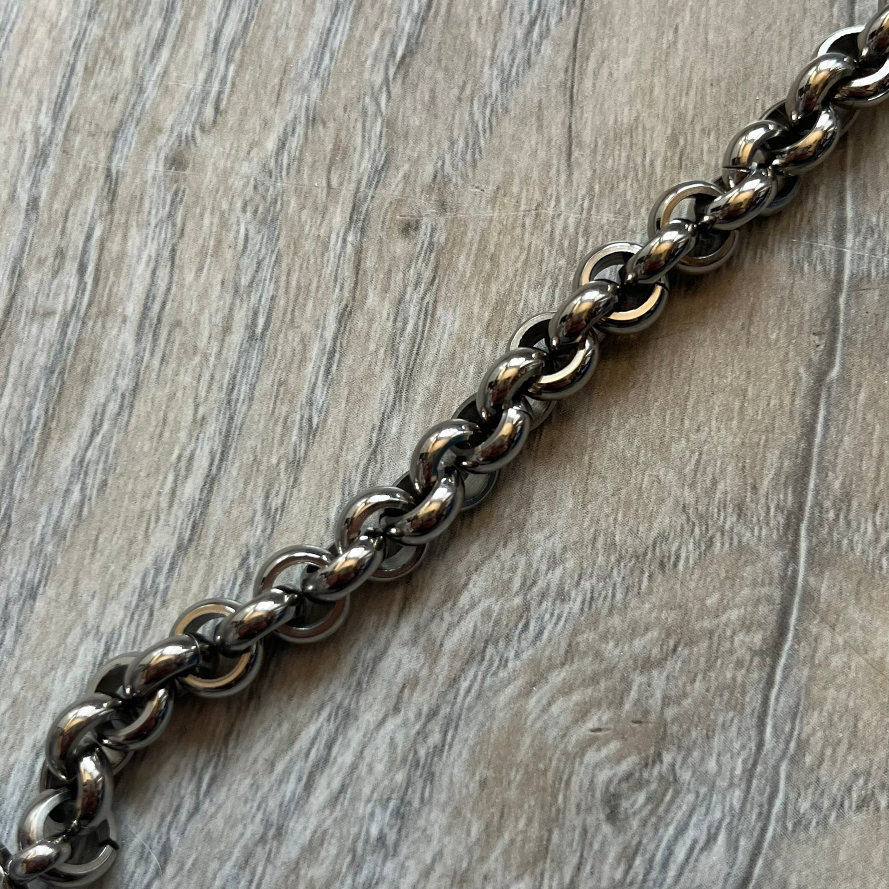 Dolce & Gabbana DJ0162 stainless steel bracelet from a three-bracelet watch set release. Constructed with round link chain segments and secured with a T-bar clasp. The clasp hardware includes engraved D&G branding on the T-bar and on the circular locking ring.