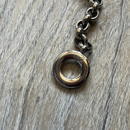 Dolce & Gabbana DJ0162 stainless steel bracelet from a three-bracelet watch set release. Constructed with round link chain segments and secured with a T-bar clasp. The clasp hardware includes engraved D&G branding on the T-bar and on the circular locking ring.