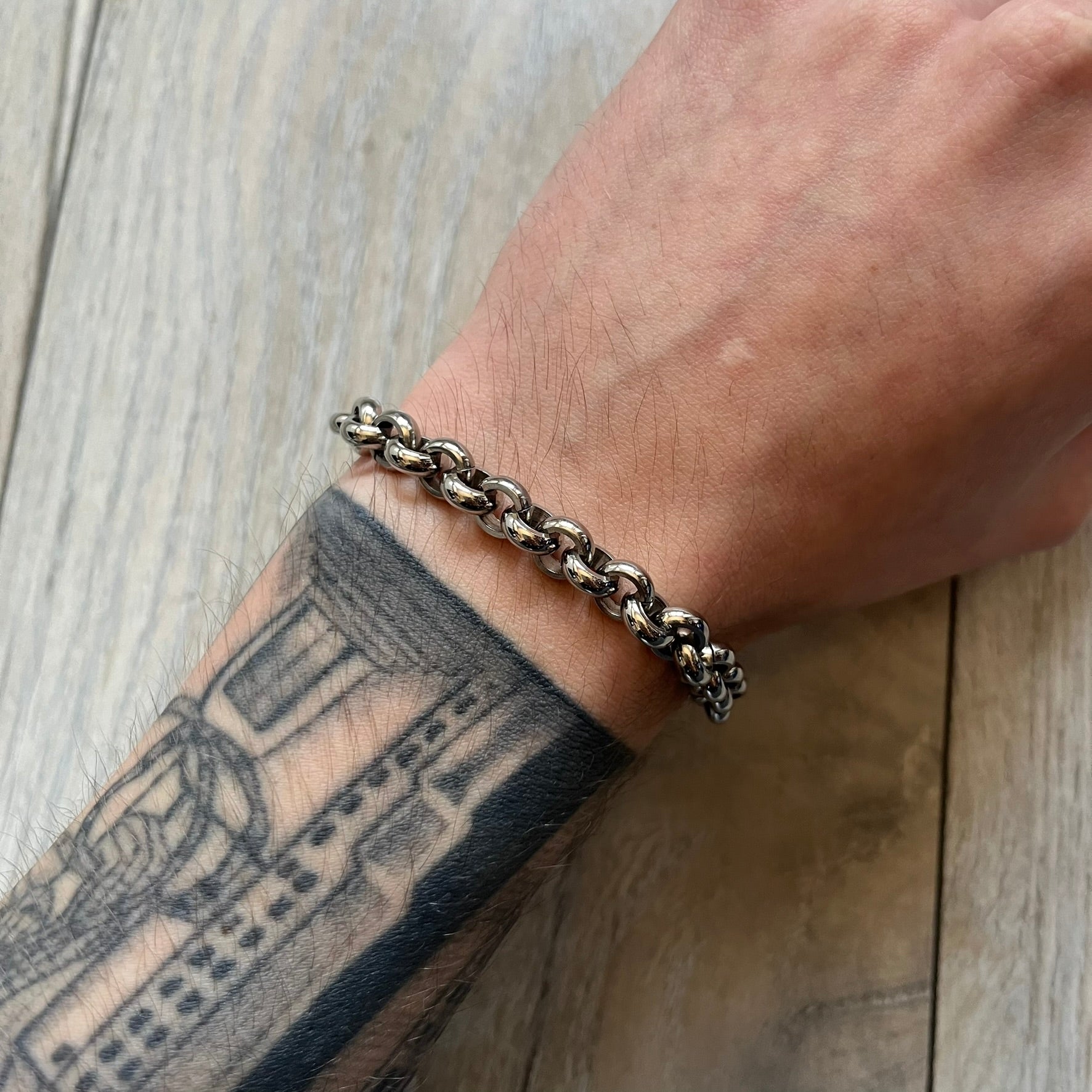 Dolce & Gabbana DJ0162 stainless steel bracelet from a three-bracelet watch set release. Constructed with round link chain segments and secured with a T-bar clasp. The clasp hardware includes engraved D&G branding on the T-bar and on the circular locking ring.