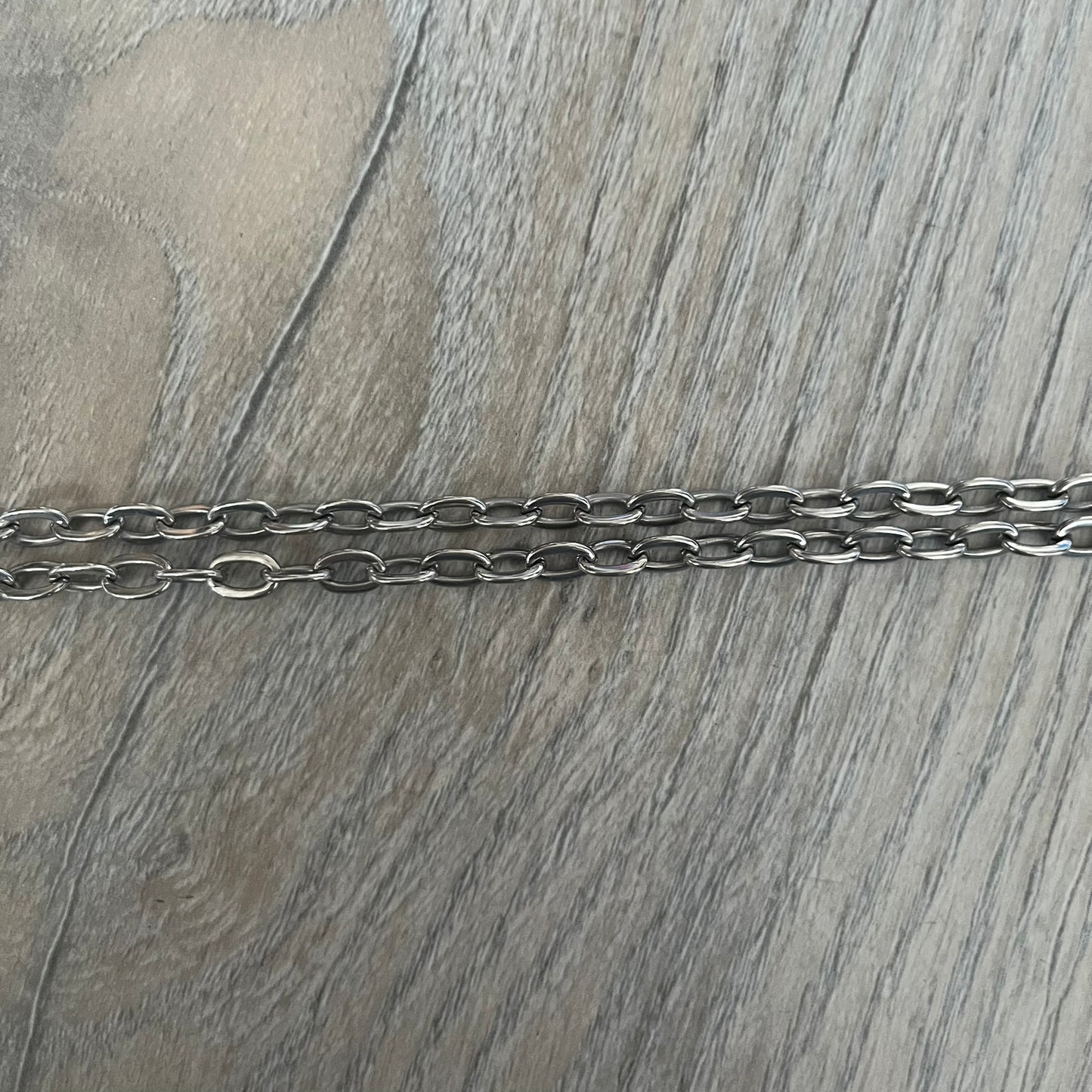 Dolce &amp; Gabbana Propaganda Dog Tag Necklace, featuring a silver stainless steel square tag with four visible screws and the D&amp;G logo engraved on the front. The tag hangs from a durable cable chain, combining sturdy construction with clean, industrial-inspired detailing.