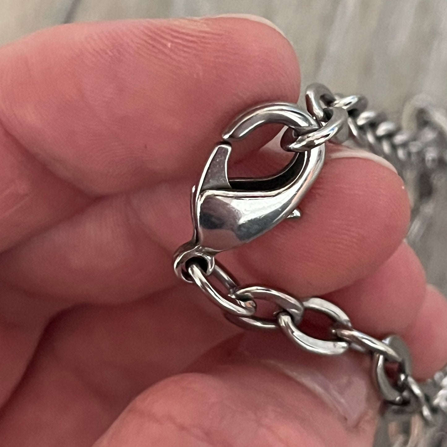 Dolce &amp; Gabbana Propaganda Dog Tag Necklace, featuring a silver stainless steel square tag with four visible screws and the D&amp;G logo engraved on the front. The tag hangs from a durable cable chain, combining sturdy construction with clean, industrial-inspired detailing.