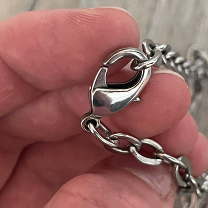 Dolce &amp; Gabbana Propaganda Dog Tag Necklace, featuring a silver stainless steel square tag with four visible screws and the D&amp;G logo engraved on the front. The tag hangs from a durable cable chain, combining sturdy construction with clean, industrial-inspired detailing.