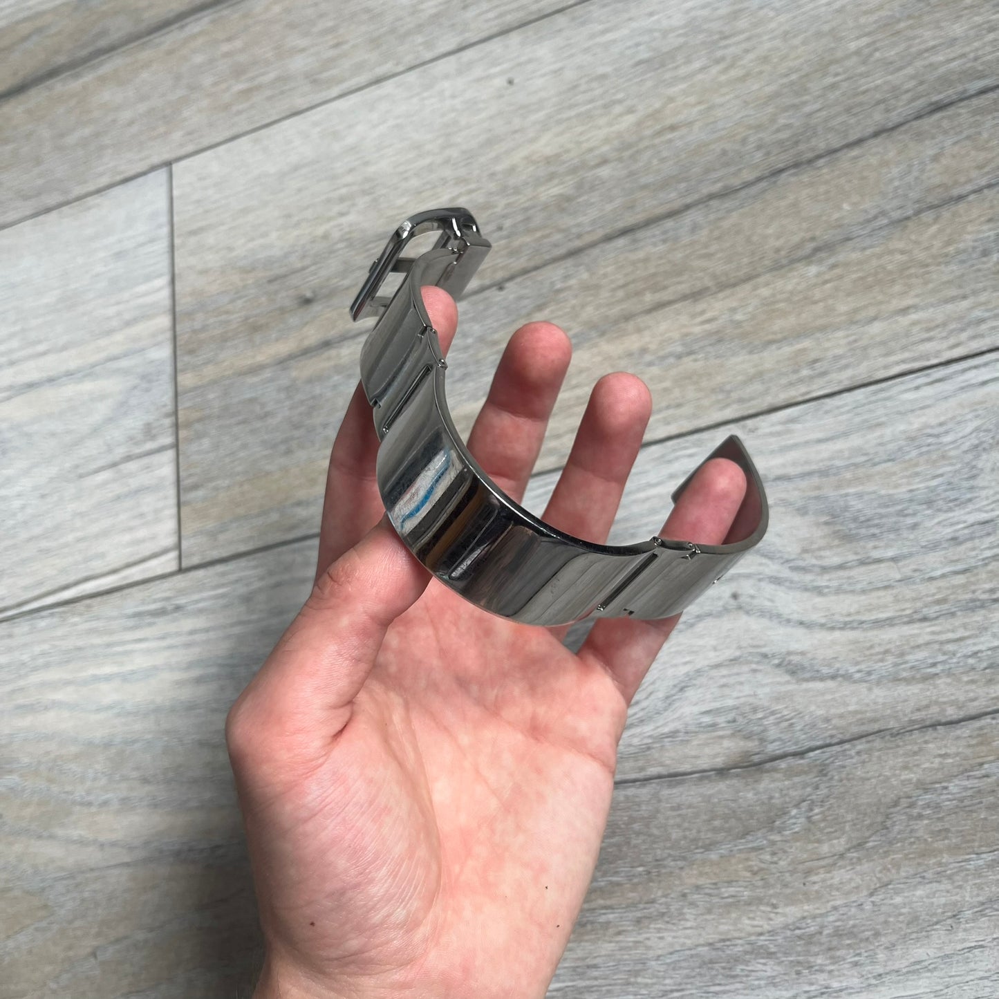 Dolce & Gabbana DJ0647 Stainless Steel Bracelet is a silver-tone stainless steel bracelet made from multiple rigid linked sections. The clasp is designed to resemble a belt buckle, with a D&G logo positioned beneath it. The bracelet follows a belt-inspired design throughout and features a polished metal finish.