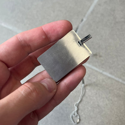 Dolce &amp; Gabbana 2000s Credit Card Necklace (DJ0772) is a rare stainless steel necklace featuring a credit card-shaped pendant. The pendant includes a large raised D&amp;G logo, an engraved D&amp;G logo, and embossed numbers inspired by a real credit card. The chain is not D&amp;G - it's a basic steel ball chain, only the pendant is from Dolce.