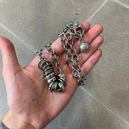 Dolce &amp; Gabbana DJ0776 Crystal Ring Link Necklace features a long stainless steel chain with freely moving rings, including basic loops, D&amp;G-engraved rings and crystal-set rings. The necklace has a large clasp, while the end is finished with a ball featuring D&amp;G logos all around it.