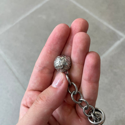 Dolce &amp; Gabbana DJ0777 Crystal Ring Link Bracelet features a stainless steel chain with freely moving rings, including basic loops, D&amp;G-engraved rings and crystal-set rings. The bracelet has a large clasp, while the end is finished with a ball featuring D&amp;G logos all around it.