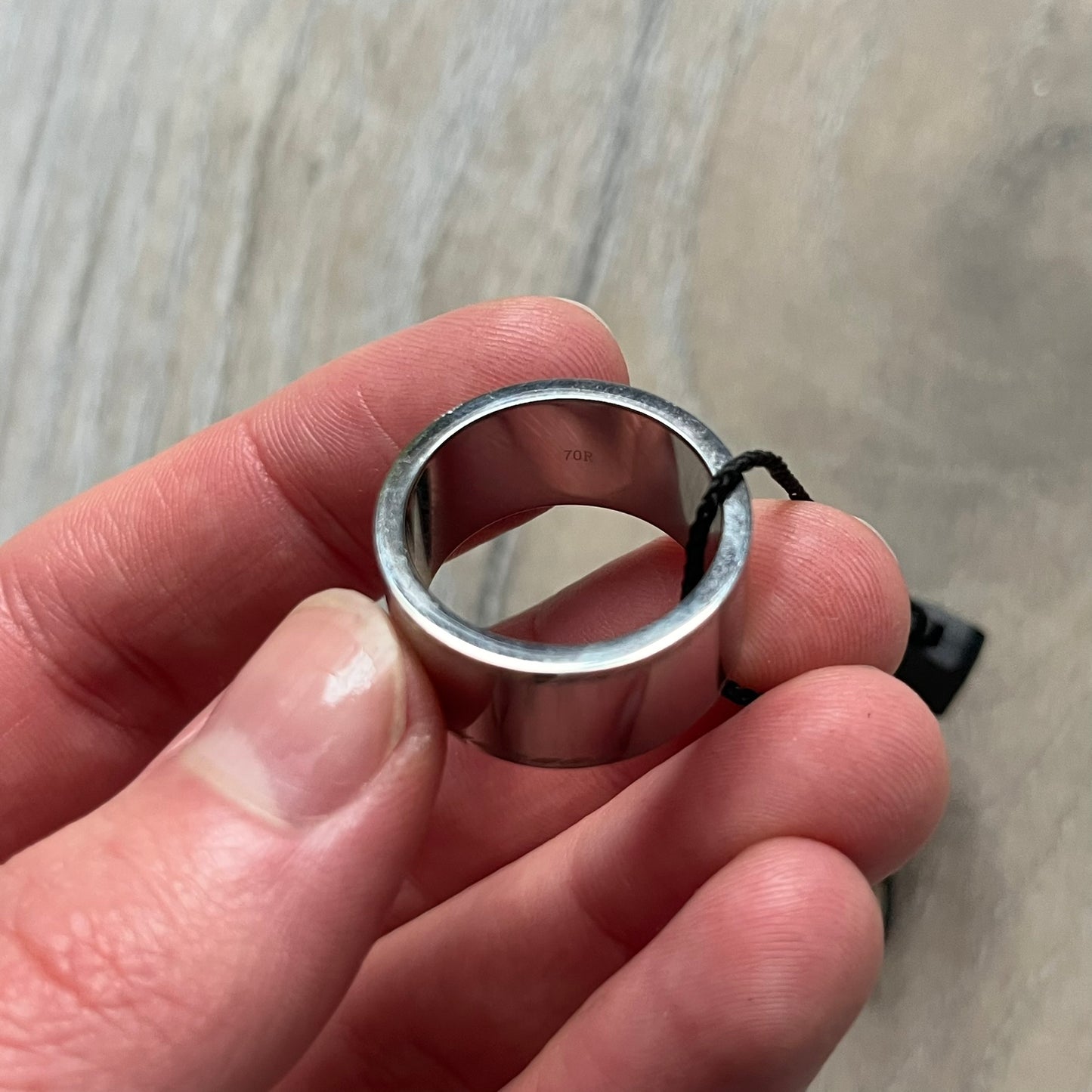 Dolce & Gabbana DJ0836 Logo Ring is a silver-tone stainless steel ring featuring engraved D&G logos in the center. The top and bottom edges have engraved rope-style lines running continuously around the band, giving it a subtle textured detail.