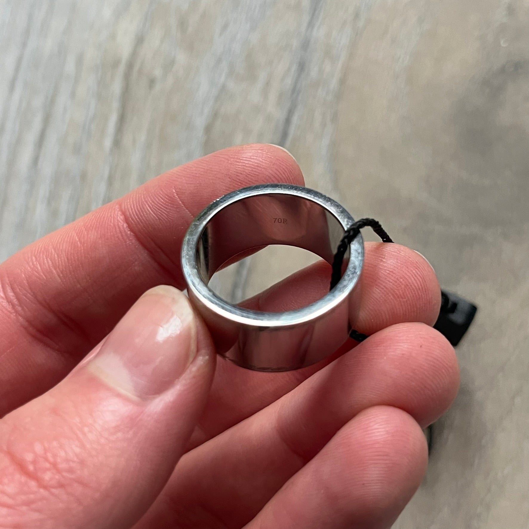 Dolce & Gabbana DJ0836 Logo Ring is a silver-tone stainless steel ring featuring engraved D&G logos in the center. The top and bottom edges have engraved rope-style lines running continuously around the band, giving it a subtle textured detail.