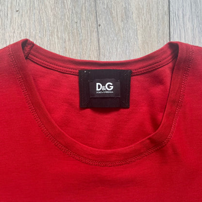 Dolce &amp; Gabbana Fall 2011 tee in vibrant red featuring a simple “Drink Coca-Cola” logo on the chest. Designed with an inside-out stitching aesthetic and a subtle back logo under the collar. A unique, collectible tee that merges casual branding with high-fashion flair.