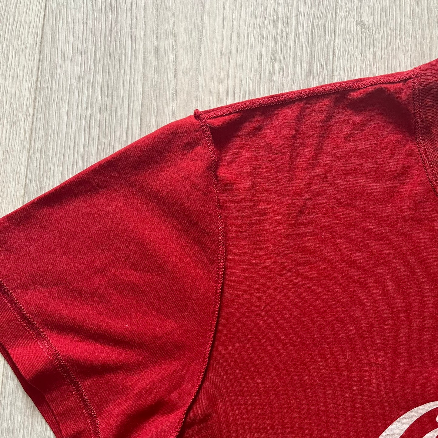 Dolce &amp; Gabbana Fall 2011 tee in vibrant red featuring a simple “Drink Coca-Cola” logo on the chest. Designed with an inside-out stitching aesthetic and a subtle back logo under the collar. A unique, collectible tee that merges casual branding with high-fashion flair.