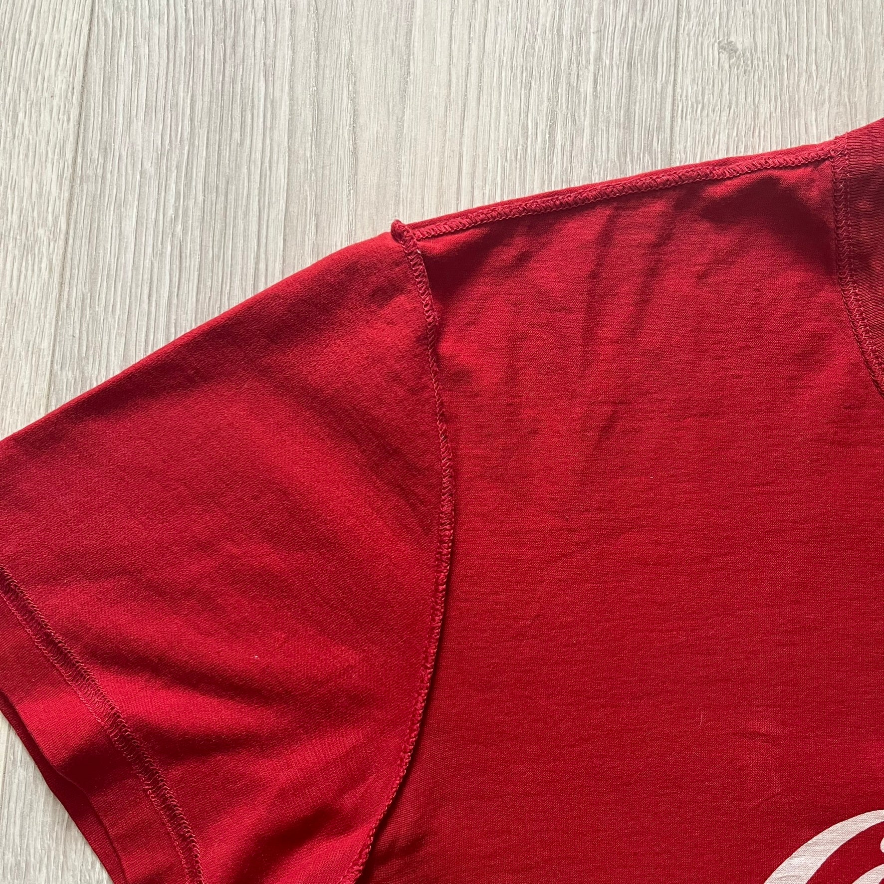Dolce &amp; Gabbana Fall 2011 tee in vibrant red featuring a simple “Drink Coca-Cola” logo on the chest. Designed with an inside-out stitching aesthetic and a subtle back logo under the collar. A unique, collectible tee that merges casual branding with high-fashion flair.