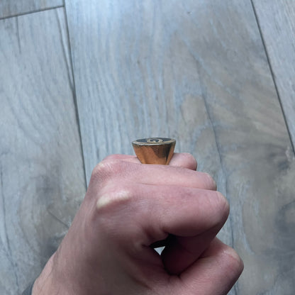 The Dolce & Gabbana Gold Logo Signet Ring is a gold-tone metal signet ring with a thick, substantial design. The top features a black background with the D&G logo in gold tone, outlined in gold. The signet is large and solid.
