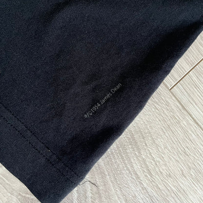 This Dolce &amp; Gabbana James Dean Black Tee features a premium Italian-made cotton construction with a front portrait of James. The design includes pretty big white/grey “James Dean” text across the upper back. The t-shirt celebrates the lasting influence of James Dean, a defining figure of mid-century cinema.