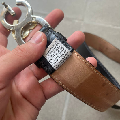 Dolce &amp; Gabbana Kids Logo Black Leather Belt features a black leather strap with a cutout DG logo buckle. The buckle combines a silver-tone “DG” design with a gold-tone ampersand detail. Made in Italy, the belt is crafted from 100% leather.