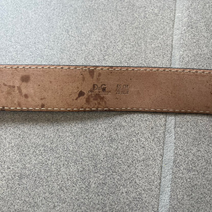 Dolce &amp; Gabbana Kids Logo Black Leather Belt features a black leather strap with a cutout DG logo buckle. The buckle combines a silver-tone “DG” design with a gold-tone ampersand detail. Made in Italy, the belt is crafted from 100% leather.