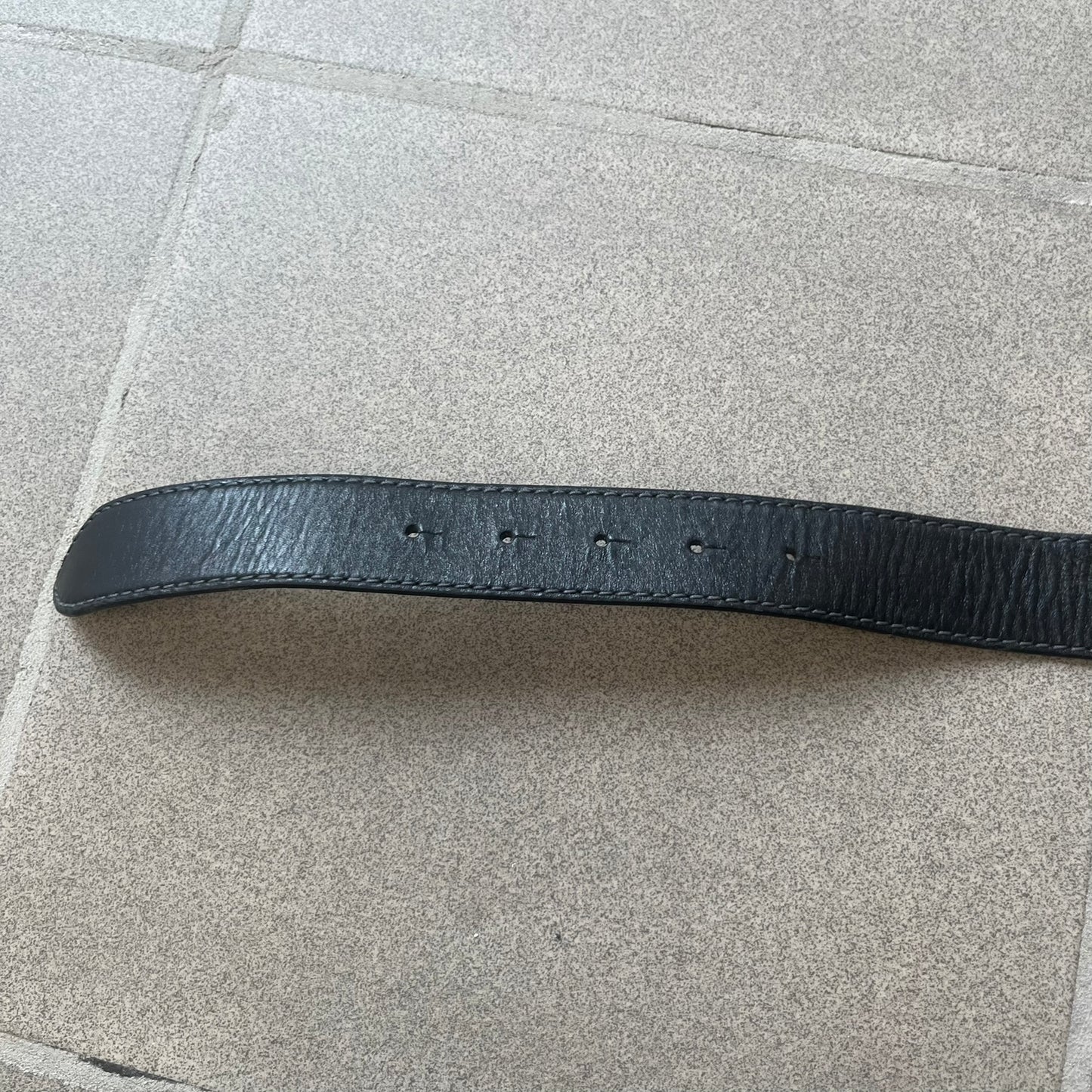 Dolce &amp; Gabbana Kids Logo Black Leather Belt features a black leather strap with a cutout DG logo buckle. The buckle combines a silver-tone “DG” design with a gold-tone ampersand detail. Made in Italy, the belt is crafted from 100% leather.
