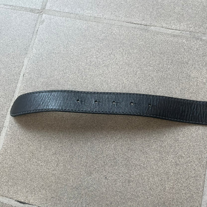 Dolce &amp; Gabbana Kids Logo Black Leather Belt features a black leather strap with a cutout DG logo buckle. The buckle combines a silver-tone “DG” design with a gold-tone ampersand detail. Made in Italy, the belt is crafted from 100% leather.