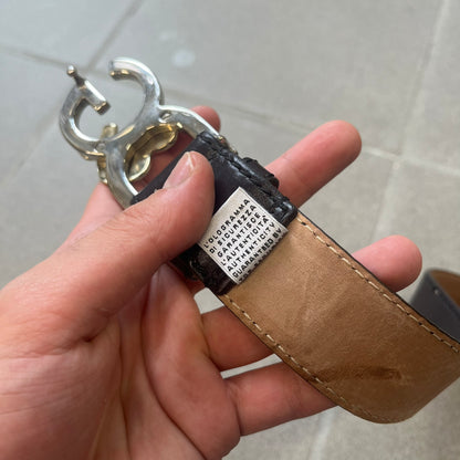 Dolce & Gabbana Kids Logo Brown Leather Belt features a brown leather strap with a cutout D&G logo buckle. The buckle combines a silver-tone “DG” design with a gold-tone ampersand detail. Made in Italy, the belt is crafted from 100% leather.
