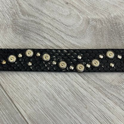 Dolce &amp; Gabbana Leather Studded Belt in black textured leather with a scaled, snake-like finish. The belt features gold stud detailing arranged in a clean pattern and a matching black D&amp;G buckle trimmed with gold hardware and exposed screws. The interior is finished in gold, adding a refined contrast to the overall design.