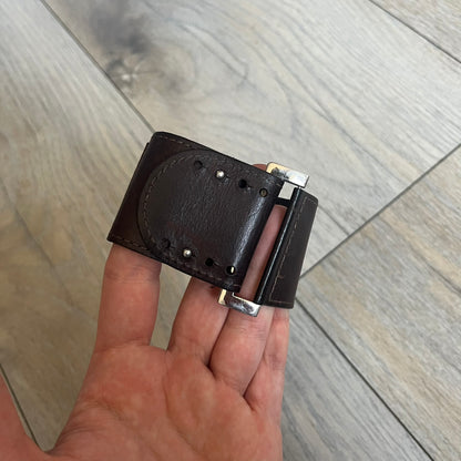 Dolce & Gabbana Logo Leather Bracelet is a leather bracelet made in Italy. It features an adjustable closure and a large stainless steel plaque on the front. The plaque is engraved with the D&G logo and Dolce & Gabbana text. Silver-tone hardware is used throughout the bracelet.