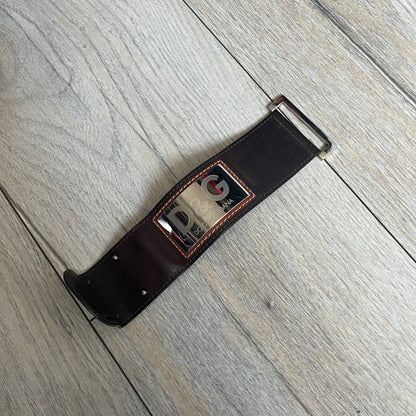 Dolce & Gabbana Logo Leather Bracelet is a leather bracelet made in Italy. It features an adjustable closure and a large stainless steel plaque on the front. The plaque is engraved with the D&G logo and Dolce & Gabbana text. Silver-tone hardware is used throughout the bracelet.