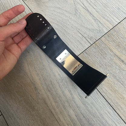 Dolce & Gabbana Logo Leather Bracelet is a leather bracelet made in Italy. It features an adjustable closure and a large stainless steel plaque on the front. The plaque is engraved with the D&G logo and Dolce & Gabbana text. Silver-tone hardware is used throughout the bracelet.