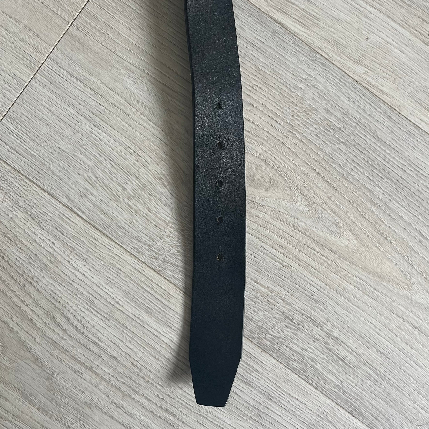 Dolce &amp; Gabbana "Made with Pride" Belt crafted from smooth black Italian leather. Features a circular silver buckle with D&amp;G 94 at the center, surrounded by “Proud to Wear D&amp;G,” “Made with Pride,” and “Established 1994” text. Finished with subtle red and navy accents, combining classic craftsmanship with contemporary flair.