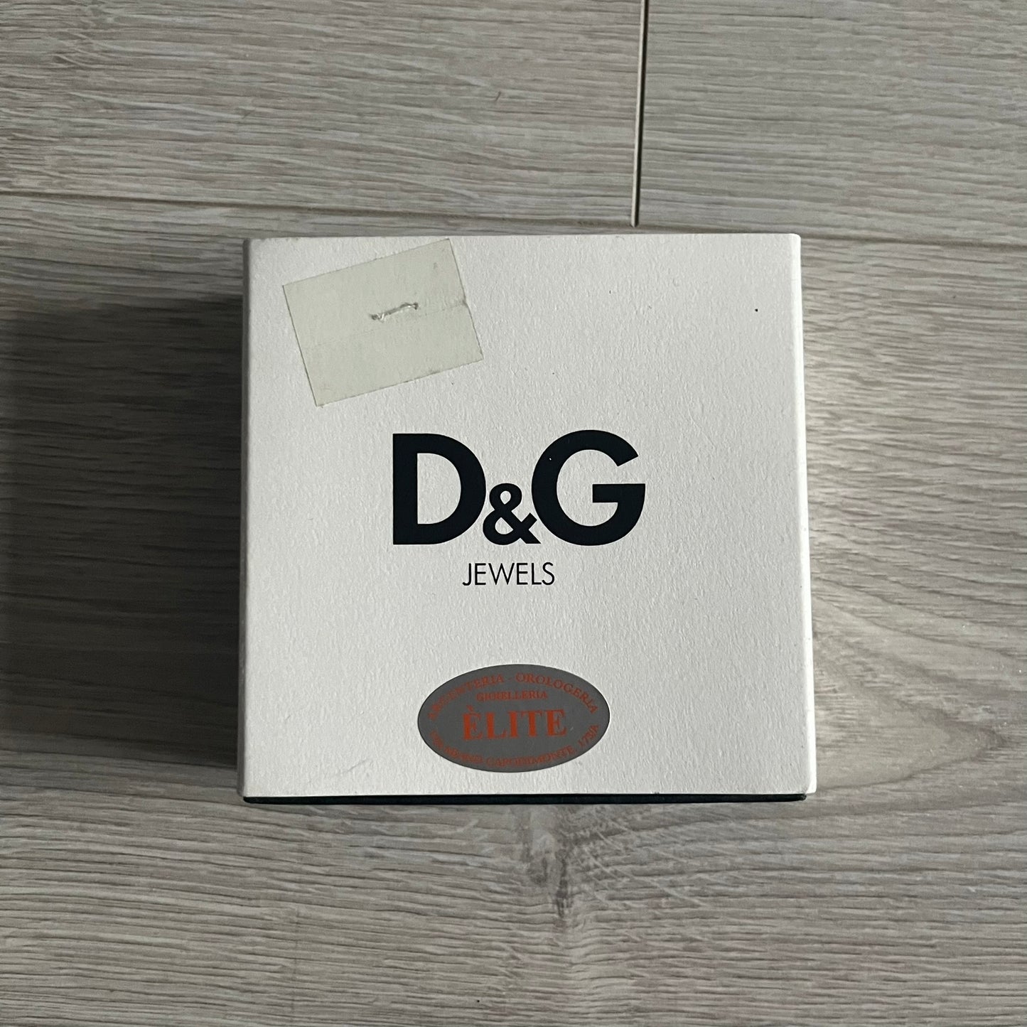 Dolce & Gabbana AW2009 Military Star Dog Tag Necklace in grey. Features a 3D black star mounted on a silver-tone metal circle with an engraved D&G logo at the bottom, suspended from a silver cable chain. Comes complete with original box and tags.