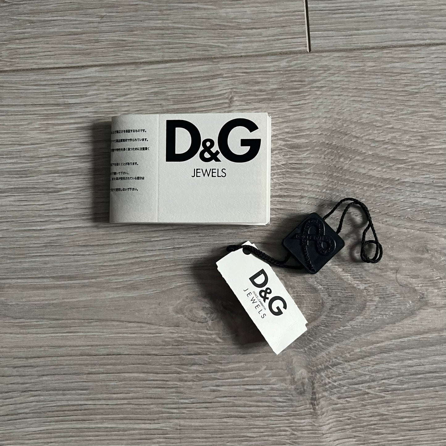 Dolce & Gabbana AW2009 Military Star Dog Tag Necklace in grey. Features a 3D black star mounted on a silver-tone metal circle with an engraved D&G logo at the bottom, suspended from a silver cable chain. Comes complete with original box and tags.