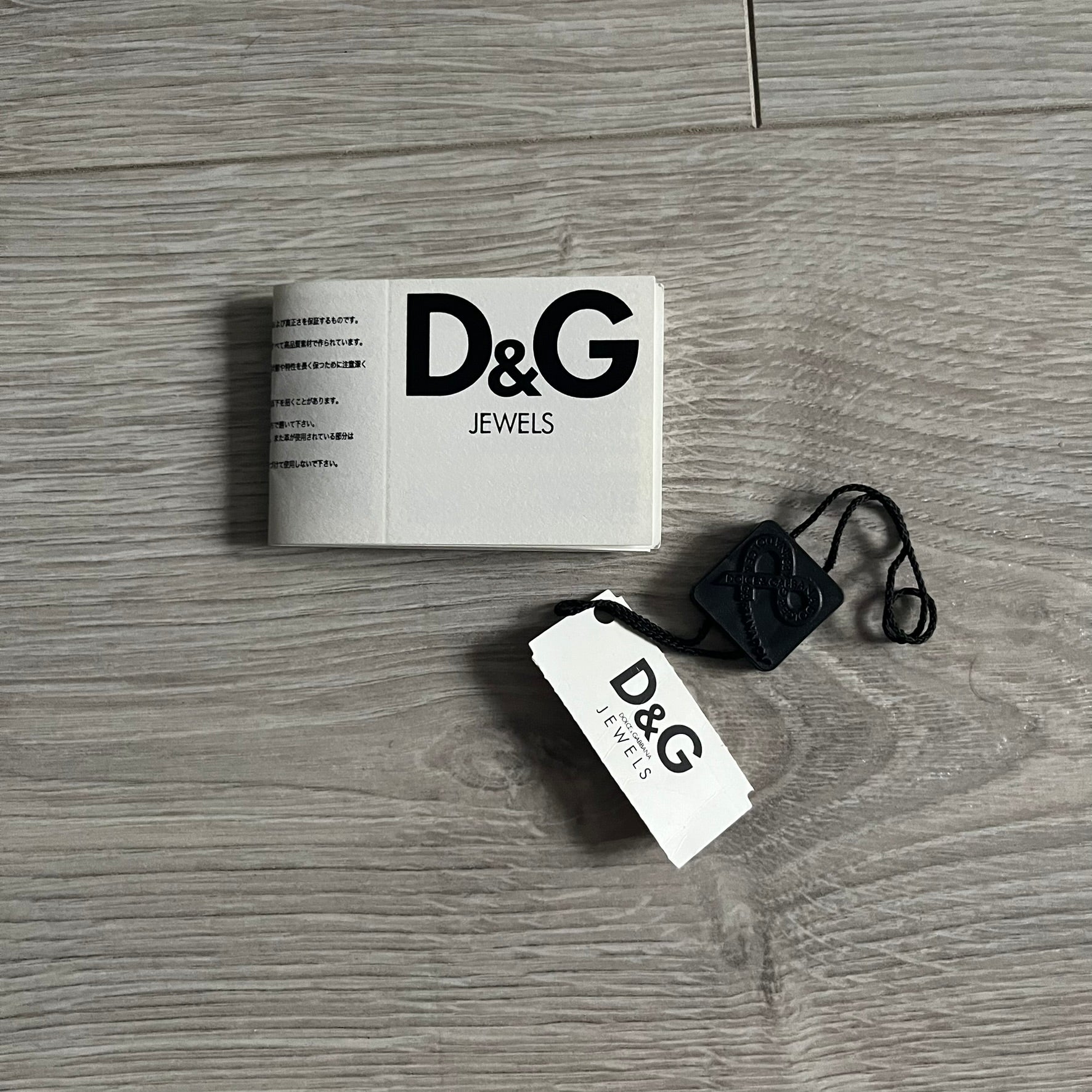 Dolce & Gabbana AW2009 Military Star Dog Tag Necklace in grey. Features a 3D black star mounted on a silver-tone metal circle with an engraved D&G logo at the bottom, suspended from a silver cable chain. Comes complete with original box and tags.