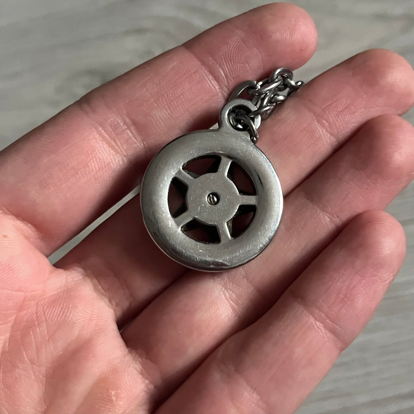 Dolce & Gabbana AW2009 Military Star Dog Tag Necklace in grey. Features a 3D black star mounted on a silver-tone metal circle with an engraved D&G logo at the bottom, suspended from a silver cable chain. Comes complete with original box and tags.