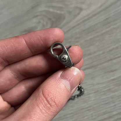 Dolce & Gabbana AW2009 Military Star Dog Tag Necklace in grey. Features a 3D black star mounted on a silver-tone metal circle with an engraved D&G logo at the bottom, suspended from a silver cable chain. Comes complete with original box and tags.