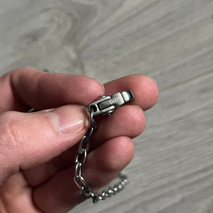 Dolce & Gabbana AW2009 Military Star Dog Tag Necklace in grey. Features a 3D black star mounted on a silver-tone metal circle with an engraved D&G logo at the bottom, suspended from a silver cable chain. Comes complete with original box and tags.