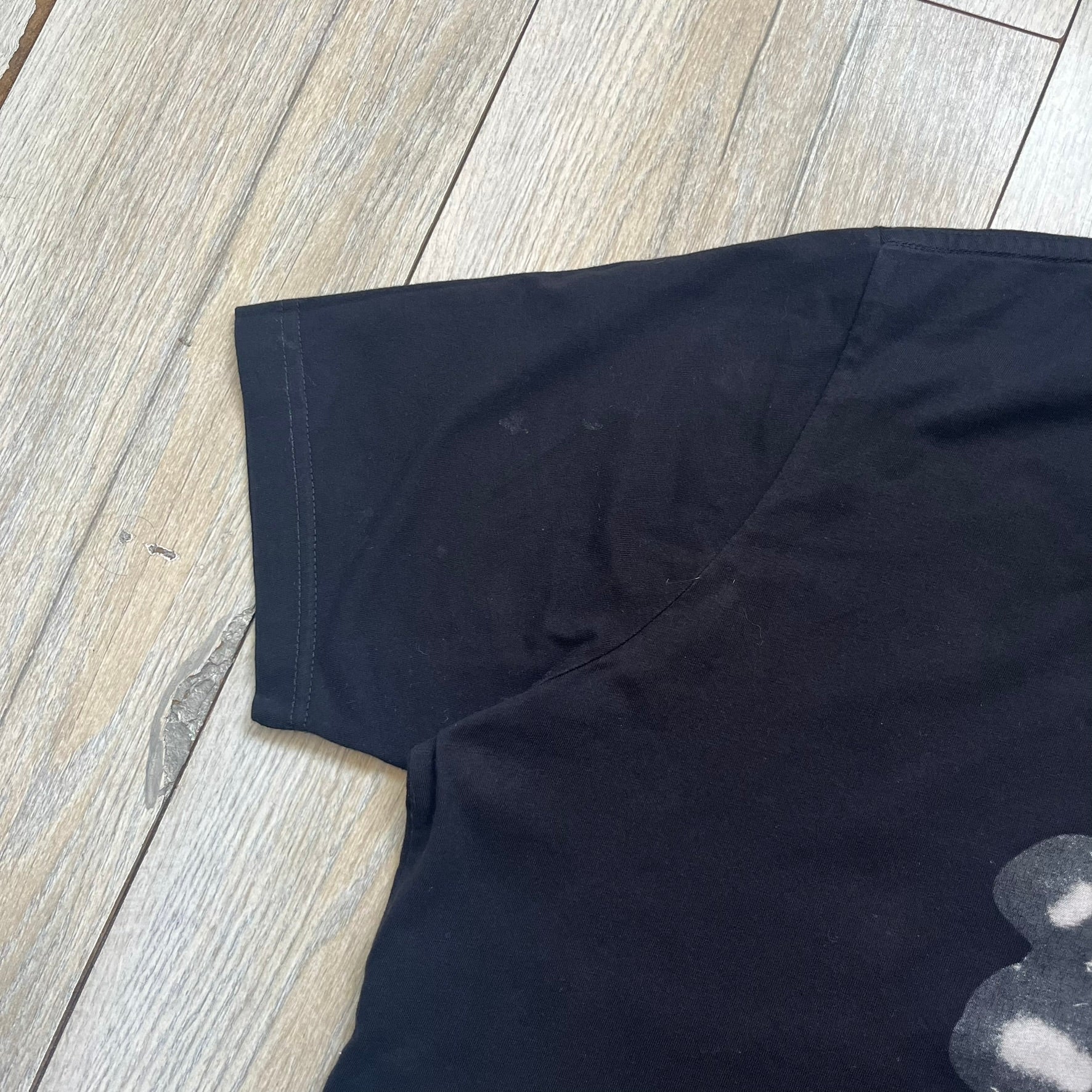  Dolce &amp; Gabbana Muhammad Ali Black Tee is a black T-shirt made in Italy from 100% cotton. The front features a grayscale portrait of Muhammad Ali. Beneath the image is the quote “float like a butterfly sting like a bee” along with a Muhammad Ali signature. 