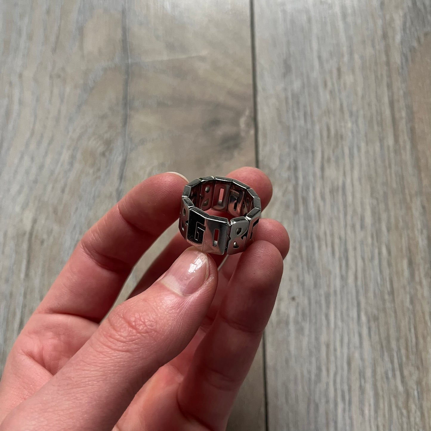 Dolce & Gabbana Overlap DJ0538 Ring is a stainless steel ring constructed entirely from cutout D&G letters. The design features 12 letters forming 4 repeating D&G sets, with each letter’s inner spaces incorporated into the openwork structure