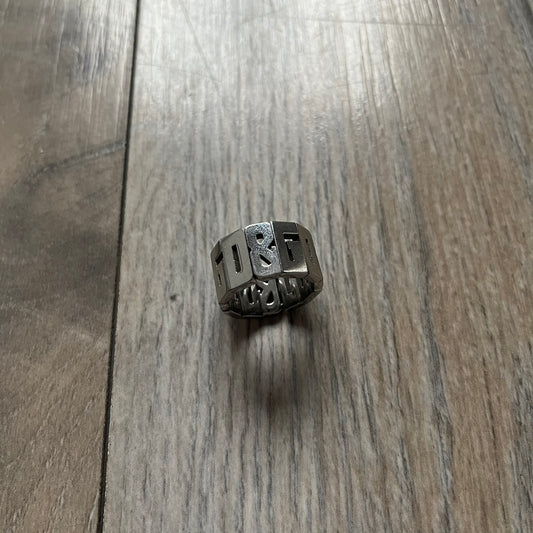 Dolce & Gabbana Overlap DJ0538 Ring is a stainless steel ring constructed entirely from cutout D&G letters. The design features 12 letters forming 4 repeating D&G sets, with each letter’s inner spaces incorporated into the openwork structure