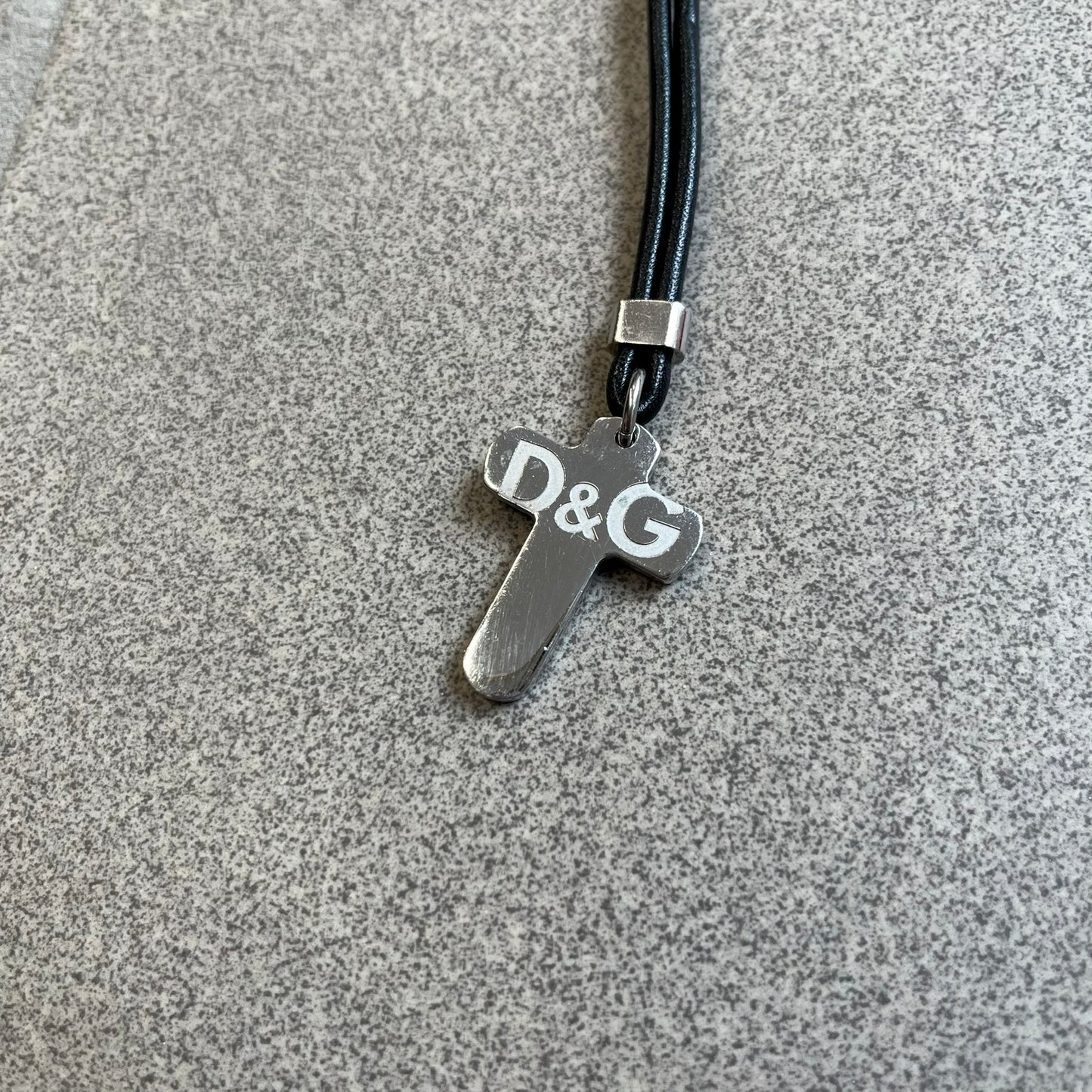 Dolce &amp; Gabbana Pearl Red/Black Rosary Necklace from the 2000's era. The necklace features a silver-tone metal cross with a D&amp;G logo, connected via a black leather link to a metal chain with alternating red and black pearl-style beads. Rosary-style construction with mixed materials including metal, leather, and resin pearls.&nbsp;