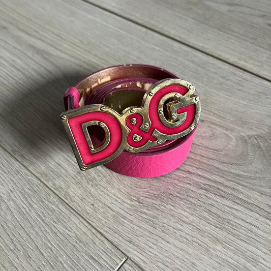 This Dolce &amp; Gabbana Belt combines a slim pink design with a statement D&amp;G buckle framed in gold and accented by visible screws. The inner side of the belt features a gold finish, highlighting the brand’s attention to material contrast. A classic Italian accessory crafted with detailed hardware.