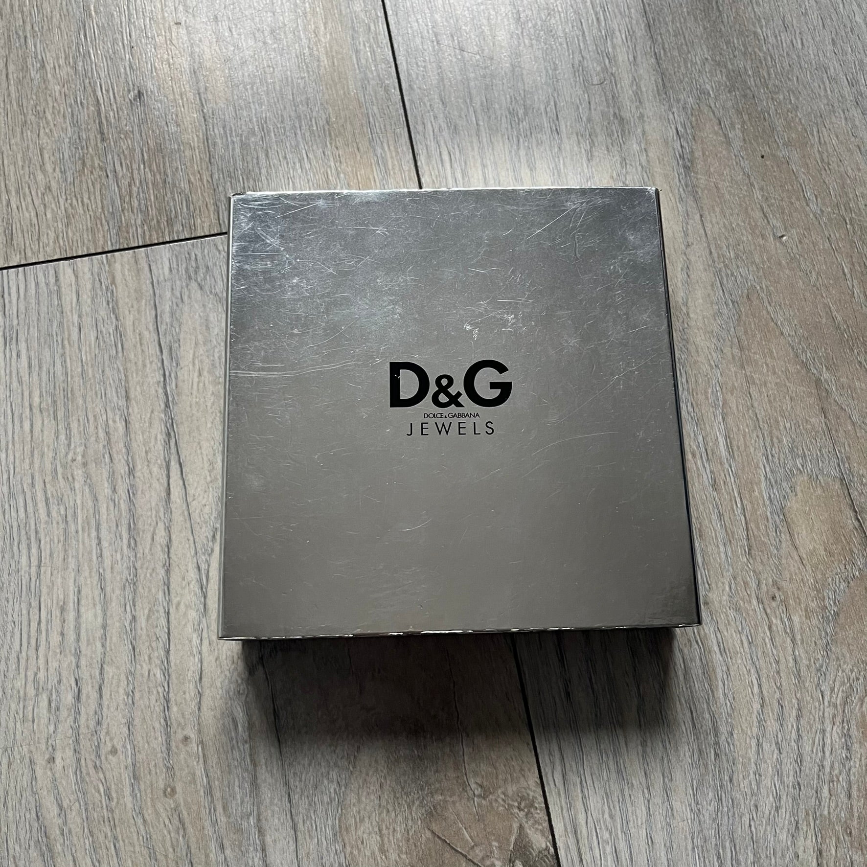 Dolce &amp; Gabbana plain logo dog tag necklace in silver-tone stainless steel, featuring the iconic D&amp;G logo engraved on a sleek tag. Suspended on a classic ball chain with a regulated size. A versatile accessory that combines minimal branding with everyday wearability.
