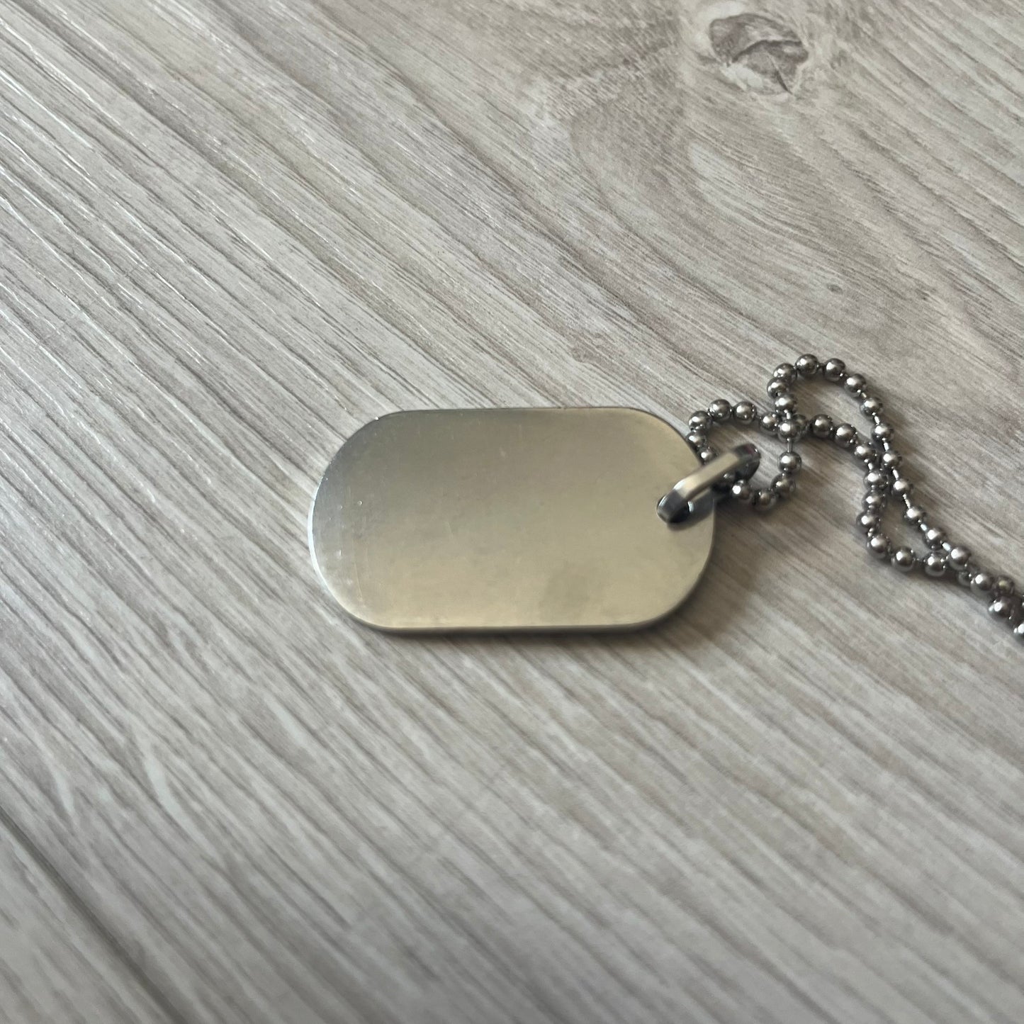 Dolce & Gabbana plain logo dog tag necklace in silver-tone stainless steel, featuring the iconic D&G logo engraved on a sleek tag. Suspended on a classic ball chain with a regulated size. A versatile accessory that combines minimal branding with everyday wearability.