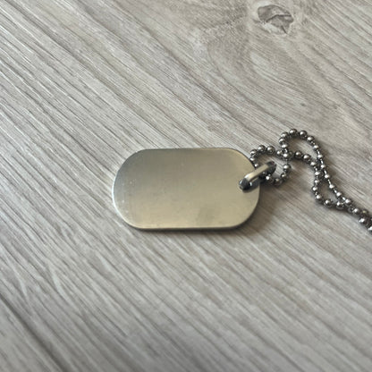 Dolce & Gabbana plain logo dog tag necklace in silver-tone stainless steel, featuring the iconic D&G logo engraved on a sleek tag. Suspended on a classic ball chain with a regulated size. A versatile accessory that combines minimal branding with everyday wearability.