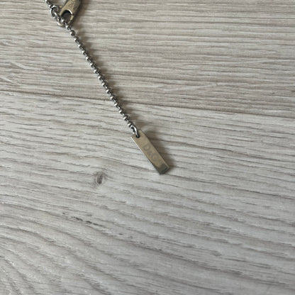 Dolce & Gabbana plain logo dog tag necklace in silver-tone stainless steel, featuring the iconic D&G logo engraved on a sleek tag. Suspended on a classic ball chain with a regulated size. A versatile accessory that combines minimal branding with everyday wearability.