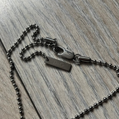 Dolce &amp; Gabbana plain logo dog tag necklace in silver-tone stainless steel, featuring the iconic D&amp;G logo engraved on a sleek tag. Suspended on a classic ball chain with a regulated size. A versatile accessory that combines minimal branding with everyday wearability.