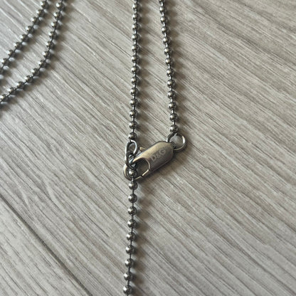 Dolce & Gabbana plain logo dog tag necklace in silver-tone stainless steel, featuring the iconic D&G logo engraved on a sleek tag. Suspended on a classic ball chain with a regulated size. A versatile accessory that combines minimal branding with everyday wearability.