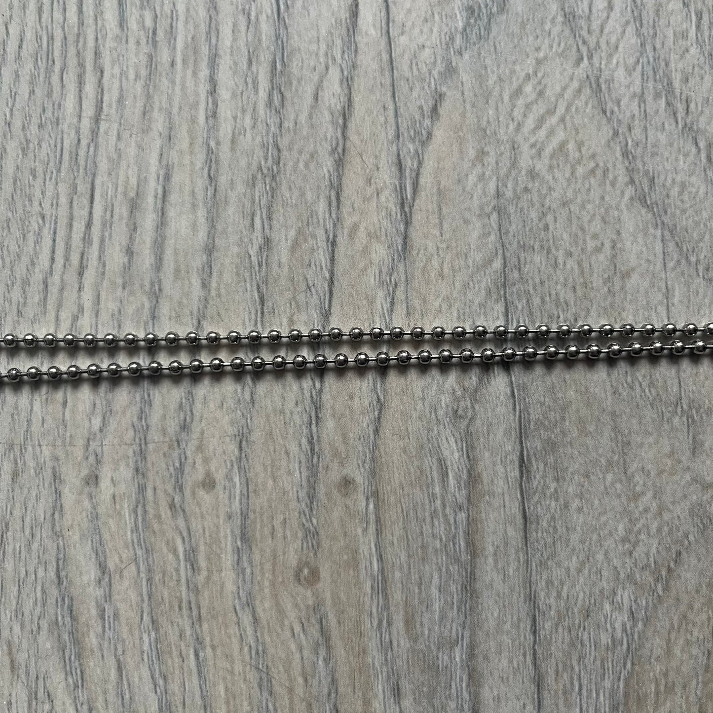 Dolce &amp; Gabbana plain logo dog tag necklace in silver-tone stainless steel, featuring the iconic D&amp;G logo engraved on a sleek tag. Suspended on a classic ball chain with a regulated size. A versatile accessory that combines minimal branding with everyday wearability.