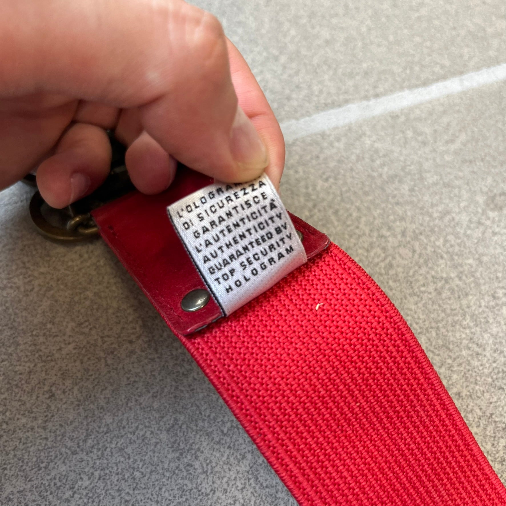 Dolce &amp; Gabbana Red Elastic Hearts Belt is made from red elastic material. The buckle is a metal D&amp;G logo surrounded by eight heart shapes pointing outward, all finished in a dark, aged-looking metal tone. The belt comes with the original hologram tag attached.