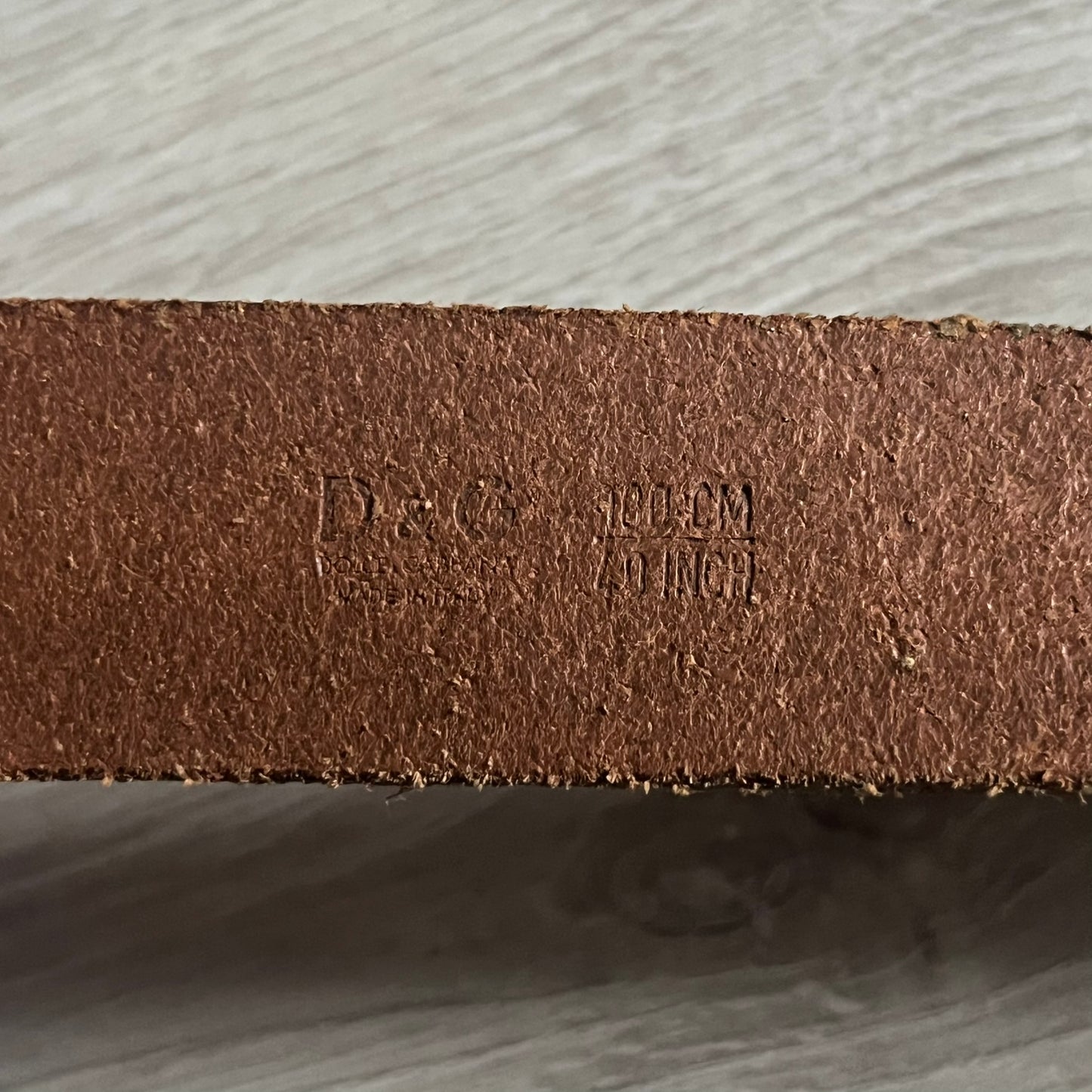 Dolce &amp; Gabbana Red &amp; Blue Leather Belt featuring a rectangular silver-tone buckle with a navy border. The buckle displays a large D&amp;G logo in blue with a red outline and “Dolce &amp; Gabbana” text in blue beneath. Finished with a brown leather strap.