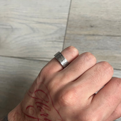 Dolce &amp; Gabbana SS04 SEX Ring is a stainless steel ring from the Spring/Summer 2004 collection. The exterior features an engraved D&amp;G logo on one side and “SEX” engraved on the opposite side. The interior is marked with a small D&amp;G logo. It has a thick band construction and polished finish.