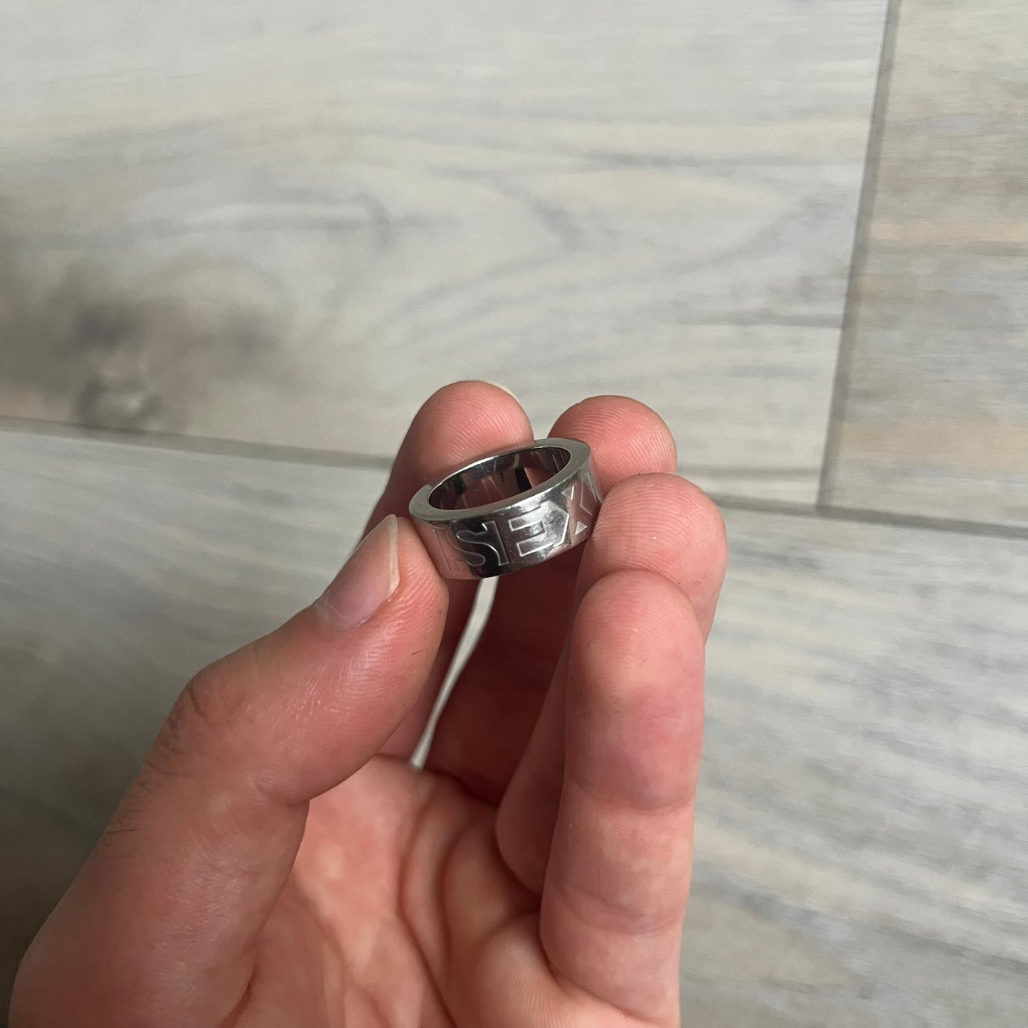Dolce &amp; Gabbana SS04 SEX Ring is a stainless steel ring from the Spring/Summer 2004 collection. The exterior features an engraved D&amp;G logo on one side and “SEX” engraved on the opposite side. The interior is marked with a small D&amp;G logo. It has a thick band construction and polished finish.